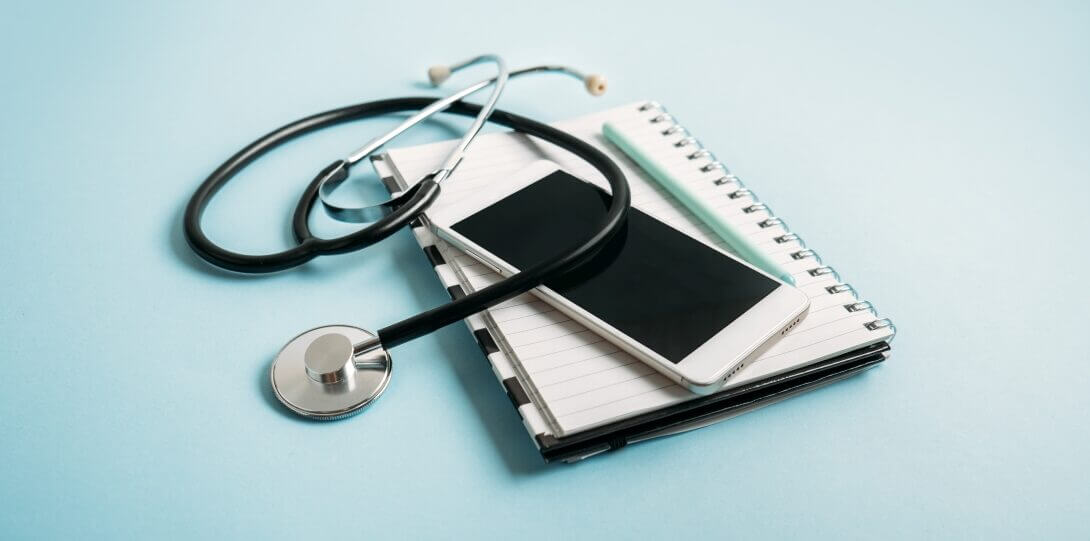 Stethoscope with phone and notebook