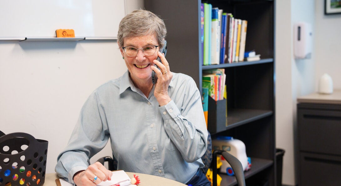 Dr. Charney on the phone smiling