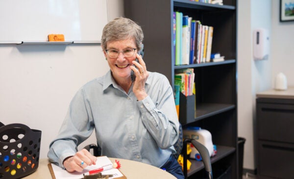 Dr. Charney on the phone smiling